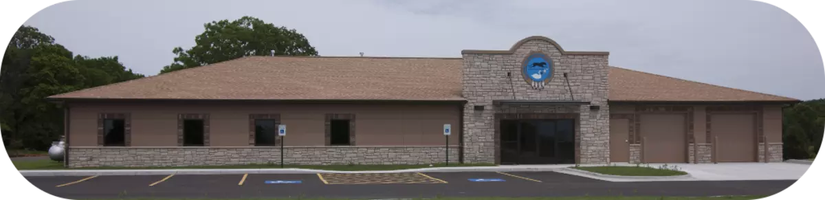 police department building behind a parking lot